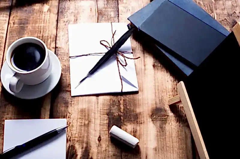 Tahta masa üzerinde kahve, kalem ve defterler – Ankara’da doçent unvanına sahip avukatlarla akademik ve ceza hukuku desteği.